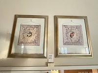 Both framed prints on wall, showing overall appearance
