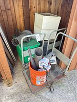 Overall view showing dollies, pipes, bucket, crates and drawers