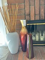 All three vases and bamboo on brick hearth