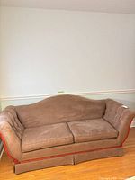 Front view of brown suede-like fabric sofa showing cushions, rolled arms and wood trim
