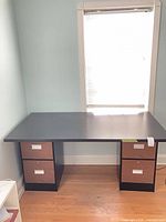 Desk setup showing both file cabinets supporting black tabletop