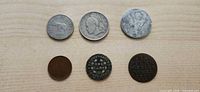 All six coins laid out, obverse or reverse visible
