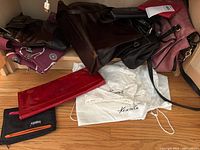 Group shot showing all bags, wallets and Kenneth Cole dust bags