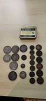 Full lot view: coins laid out with metal tin