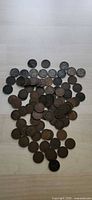 Full lot of scattered Indian Head cents on tabletop