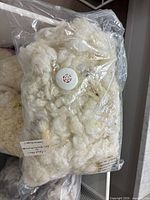 Sealed plastic bag containing white fleece