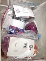 Overview of several bags of dyed wool roving with labels