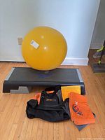 Group shot showing Reebok step, yellow ball, Orangetheory bag, towel, tracker