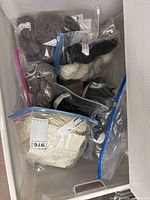 Drawer containing multiple clear bags of assorted coloured yarn skeins
