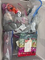 Overview of all five zipper bags of yarn in bin