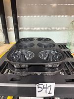 Two stacked Nordic Ware mini Bundt pans on shelf