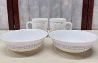 Front view of 2 bowls and 2 mugs showing pattern and form