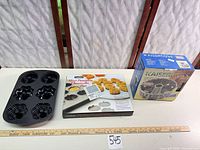 Three bake pans: one loose 6-cavity mini bundt, two boxed pans