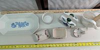 Overall view of platter, trinket boxes, vase, cup, spoon rest with measuring tapes for scale