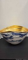 Full view of blue and white marble pattern bowl with gold interior