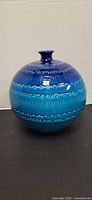 Full view of spherical blue vase