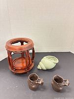 Group shot: two brown cups, shell porcelain vase, wooden stand