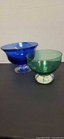 blue and green footed glass bowls side by side