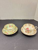 Both Paragon cup and saucer sets side by side showing patterns and condition