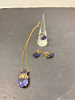 Full view of necklace, earrings and ring