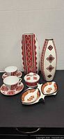 Full lot: two vases, cups, saucers, plates, lidded dish