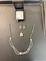 Entire lot on tray: necklace, pendant, filigree earrings, rhinestone earrings in box