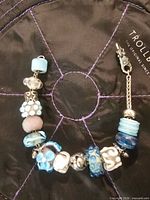 Full view of charm bracelet laid on Trollbeads pouch