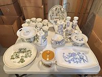 Full lot overview on table showing mixed dinnerware patterns