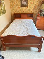 Full view of assembled bed with headboard, footboard, mattress