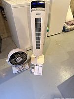 Full view of both fans, remote and manual visible