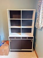 Front view showing full bookcase with shelves, drawers, cabinet