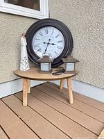 Overall lot showing clock, table, figurine, lanterns, hooks