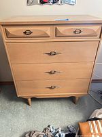Front view showing five drawers and pulls
