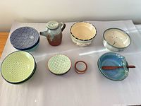 Overview of all ceramic pieces laid out on surface