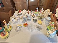 Overall view of assorted figurines, dishes, ornaments on table