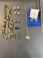 Full lot overview showing necklace, bracelet, and all earring pairs
