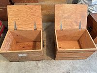 Both crates open showing interiors and lid hinges