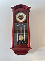 Front view of Seiko wall clock showing dial, pendulum and wooden case