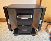 Jewelry box open showing drawers and side doors with hooks