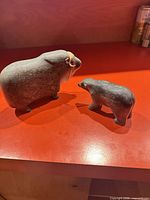 Front three-quarter view of both soapstone sculptures