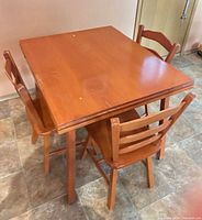 table with three chairs around it, showing top surface and finish