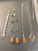 Full layout of bracelet, necklaces, ring and earrings