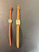 Both watches front view showing dials, straps, cases