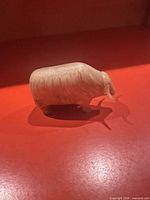 Side view of muskox bone figurine showing full profile