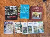 Group shot of all nine books and pamphlets laid out on floor