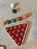 Full set of red balls racked with coloured balls and cue ball shown