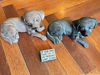 Both dog figurines and the sign displayed together