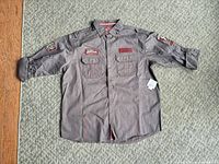 Full front view of Snap-on shirt laid flat showing pockets, patches and new tag