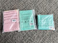 Front view of three sealed Tupperware microfiber cloth packs showing colors and packaging