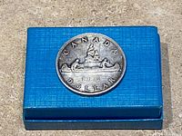 Reverse side showing canoe design and date 1953